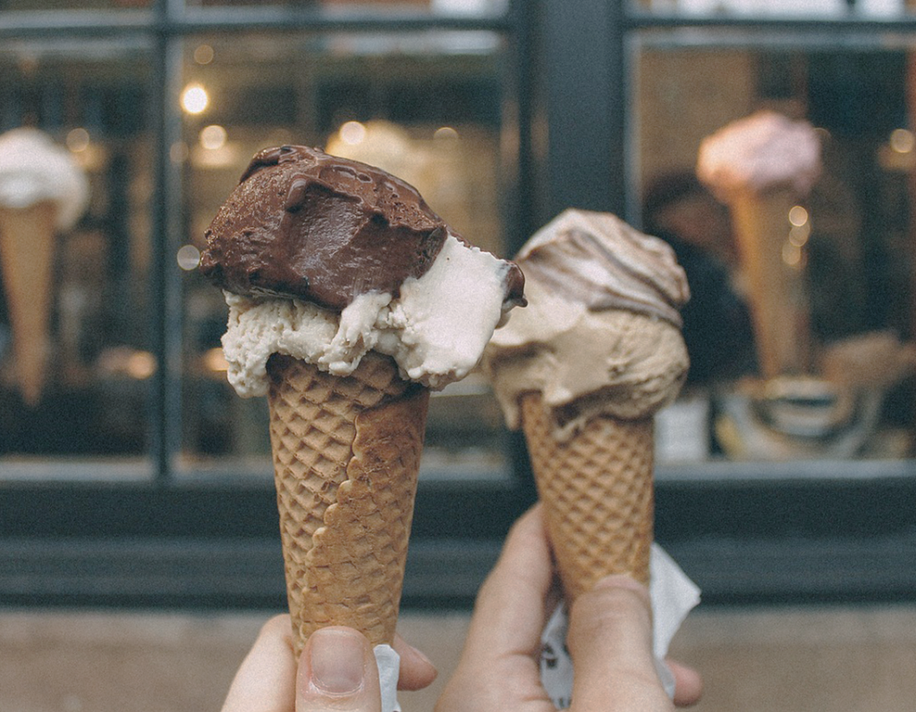 ice cream cones ahead of the storefront. chocolate ice cream on a cone.